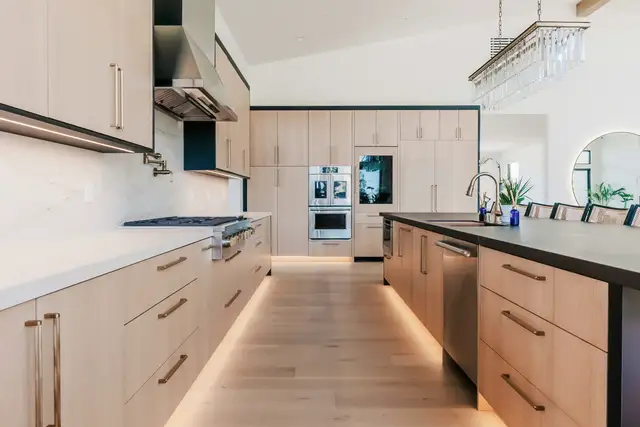 Long light-wood kitchen with a dark island