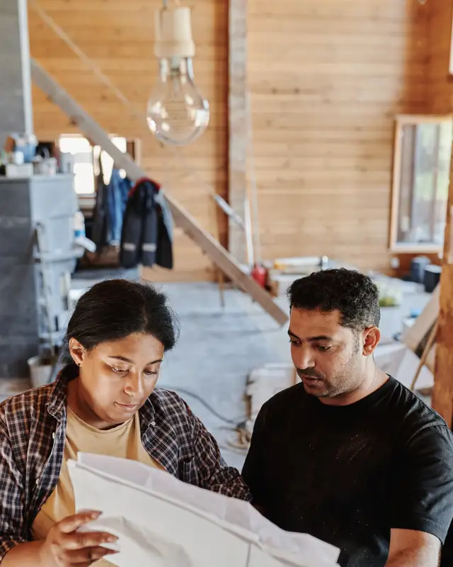 Stand-in portrait of a builder reading drawings on site